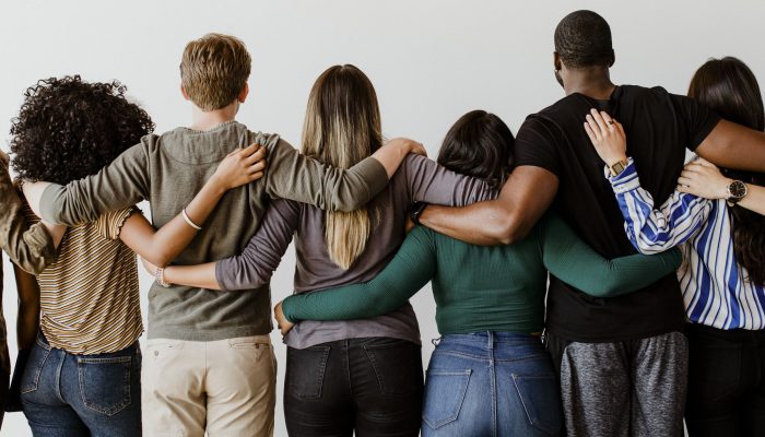 rearview-diverse-people-hugging-each-other.jpg