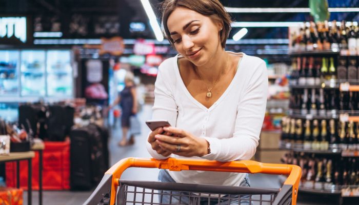 woman-shopping-grocery-store-talking-phone.jpg